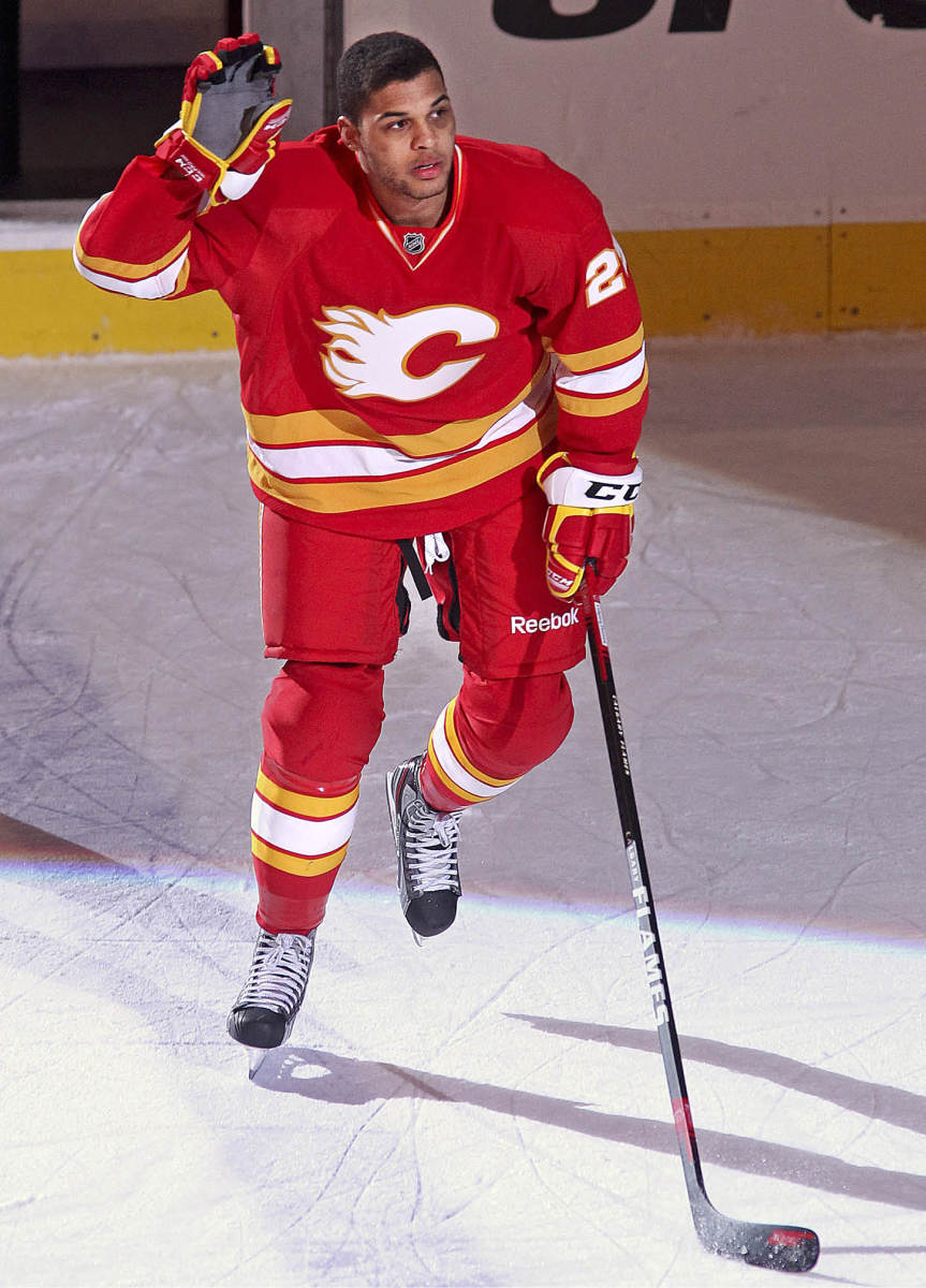 UNKIND CUT Aliu had two goals and an assist in his first two games for Calgary—but had to play without his Afro, which he shaved off to avoid standing out.